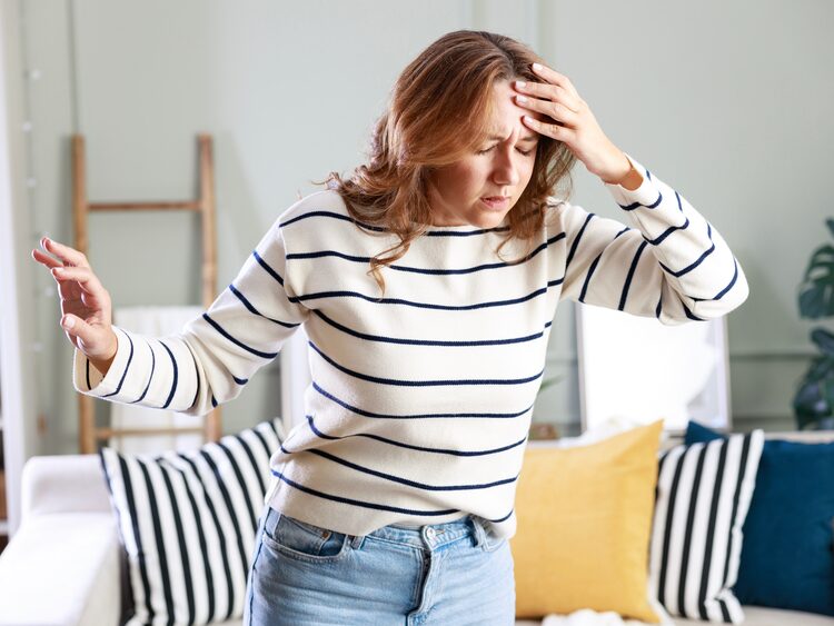 Woman experiencing a sudden spinning vertigo episode before BPPV treatment in Mesa, AZ