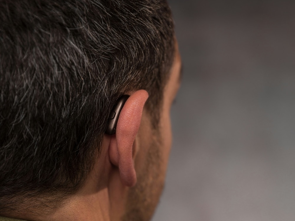 Doctor of Audiology programming a new hearing aid during a fitting at AFA Balance & Hearing Institute in Mesa, AZ