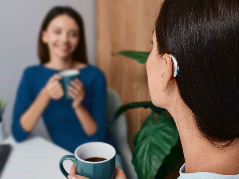 Woman wearing a receiver-in-canal hearing aid, one of several hearing aid styles fitted at AFA Balance & Hearing Institute in Mesa, AZ
