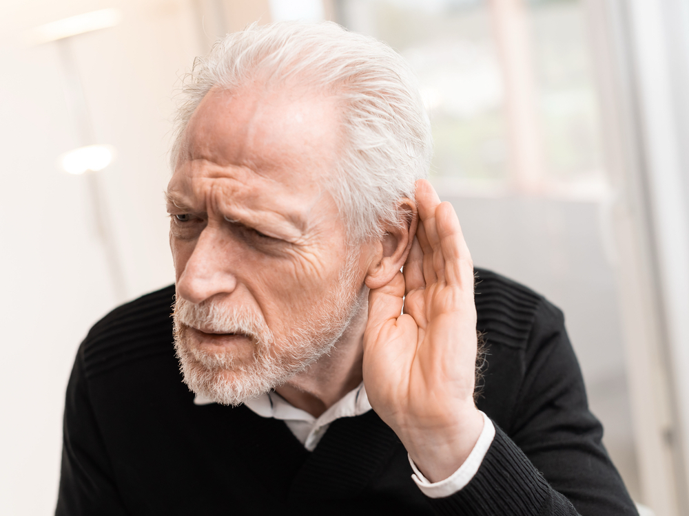 Patient reviewing an audiogram showing sensorineural, conductive, and mixed types of hearing loss at AFA Balance & Hearing Institute in Mesa, AZ