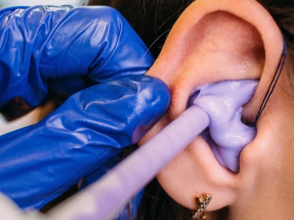 Doctor of Audiology taking a custom ear impression for hearing protection at AFA Balance & Hearing Institute in Mesa, AZ